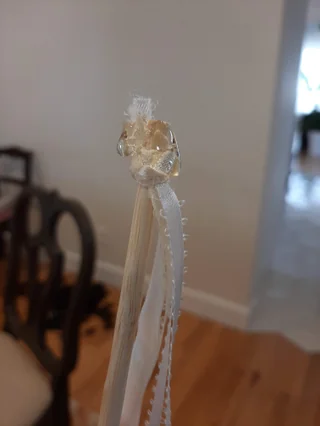 Ribbons knotted and hot glued to the end of the stick